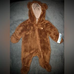 NWT. Unisex teddy bear footies made by carters. Available size is newborn.